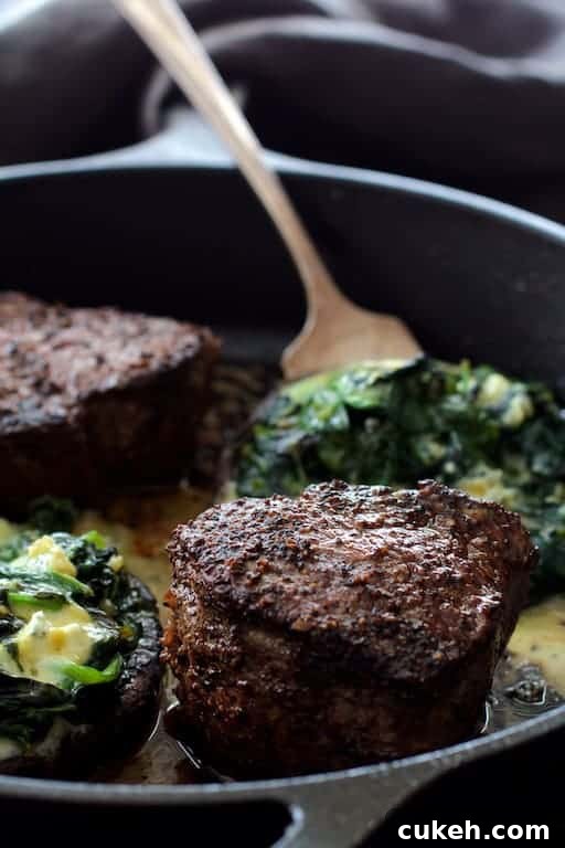 Beef Tenderloin Fillets with Spinach-Stuffed Portobello Mushrooms 7 Process photo of Beef Tenderloin Fillets with Spinach Cambozola Stuffed Mushrooms being cooked together in cast iron skillet.