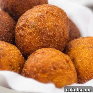 a bowl of golden brown round hush puppies
