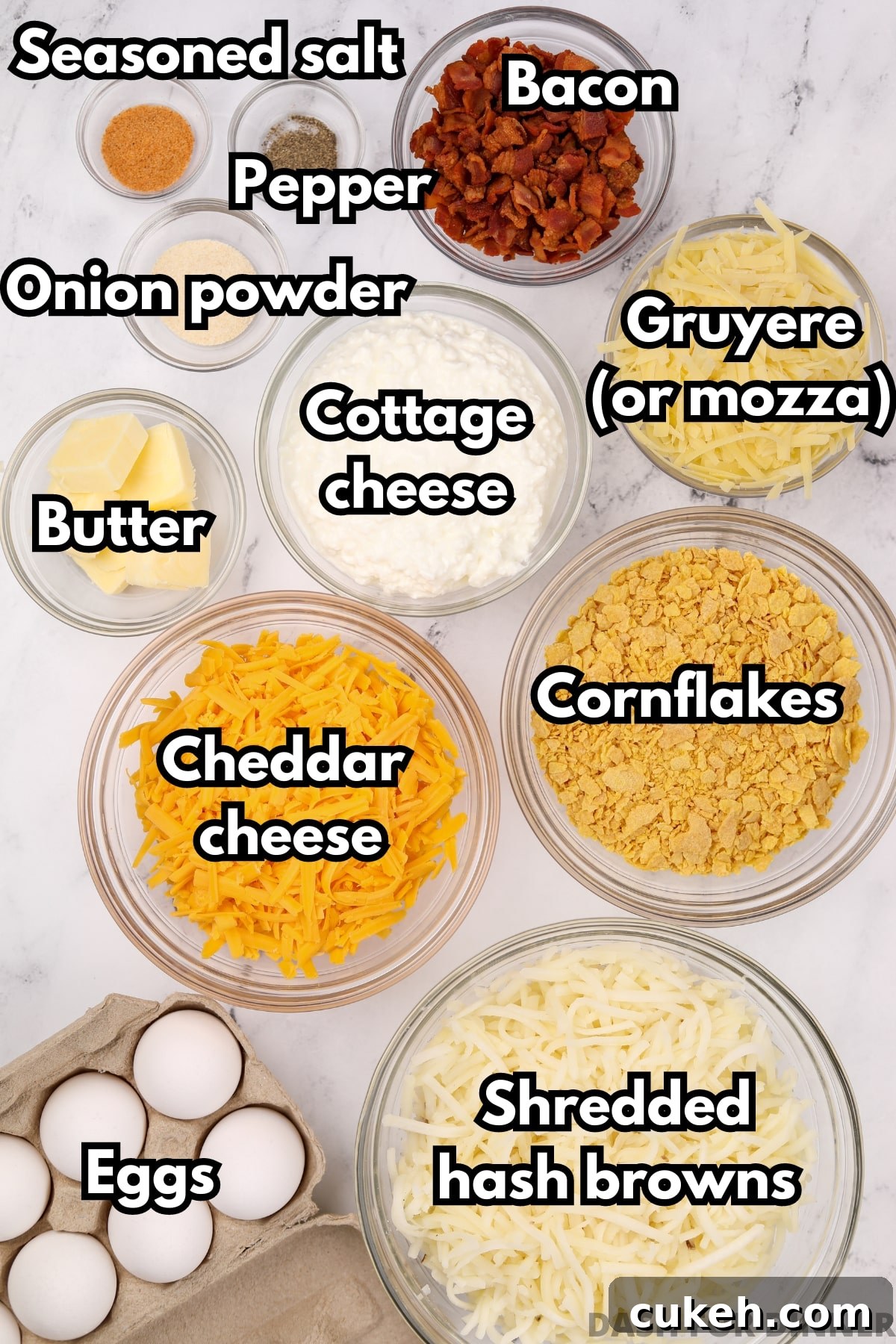 The ingredients needed to make a breakfast casserole with shredded hash browns, including cheese, bacon, eggs, cottage cheese, and butter.