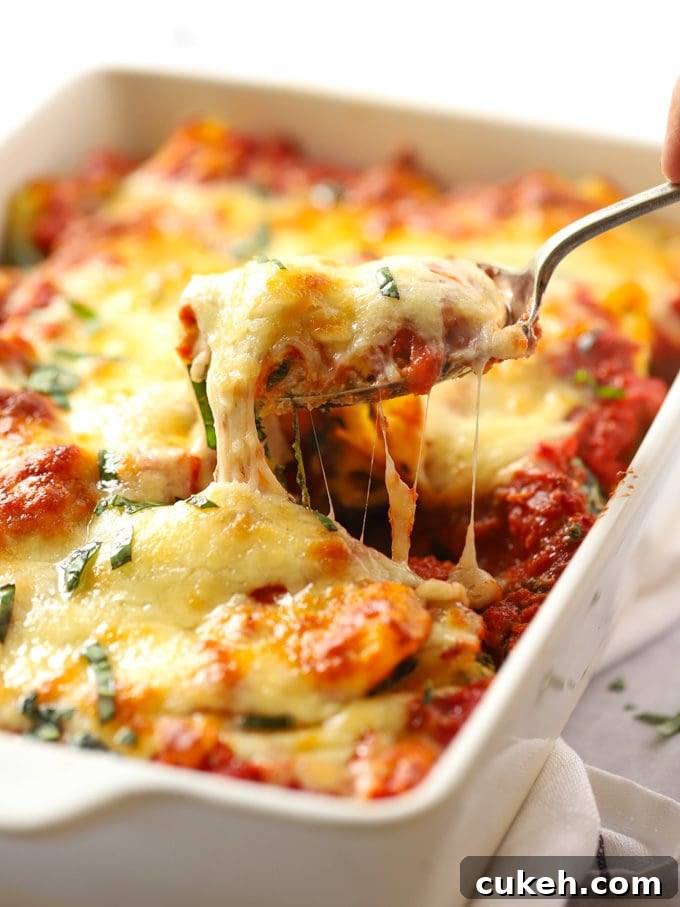 Cheese pulling from a Spinach and Ricotta Pasta Bake recipe.