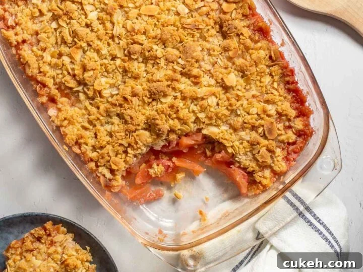Top-down view of a fruit crisp in a glass dish.