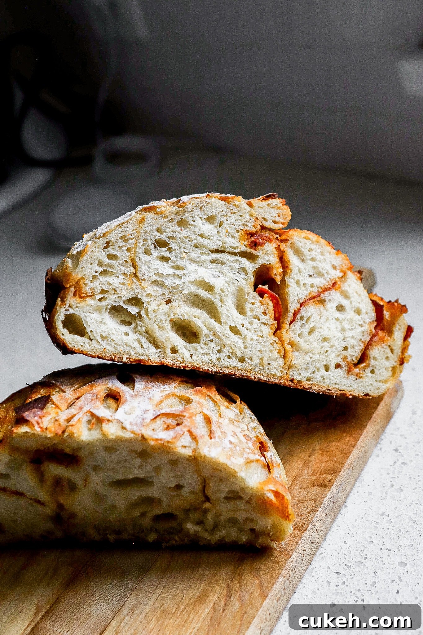 Side view of pepperoni pizza sourdough bread stacked on top of one another.
