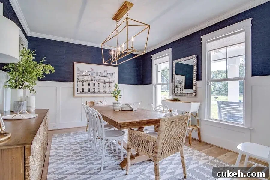 a navy blue dining room with visual comfort darlana light fixture