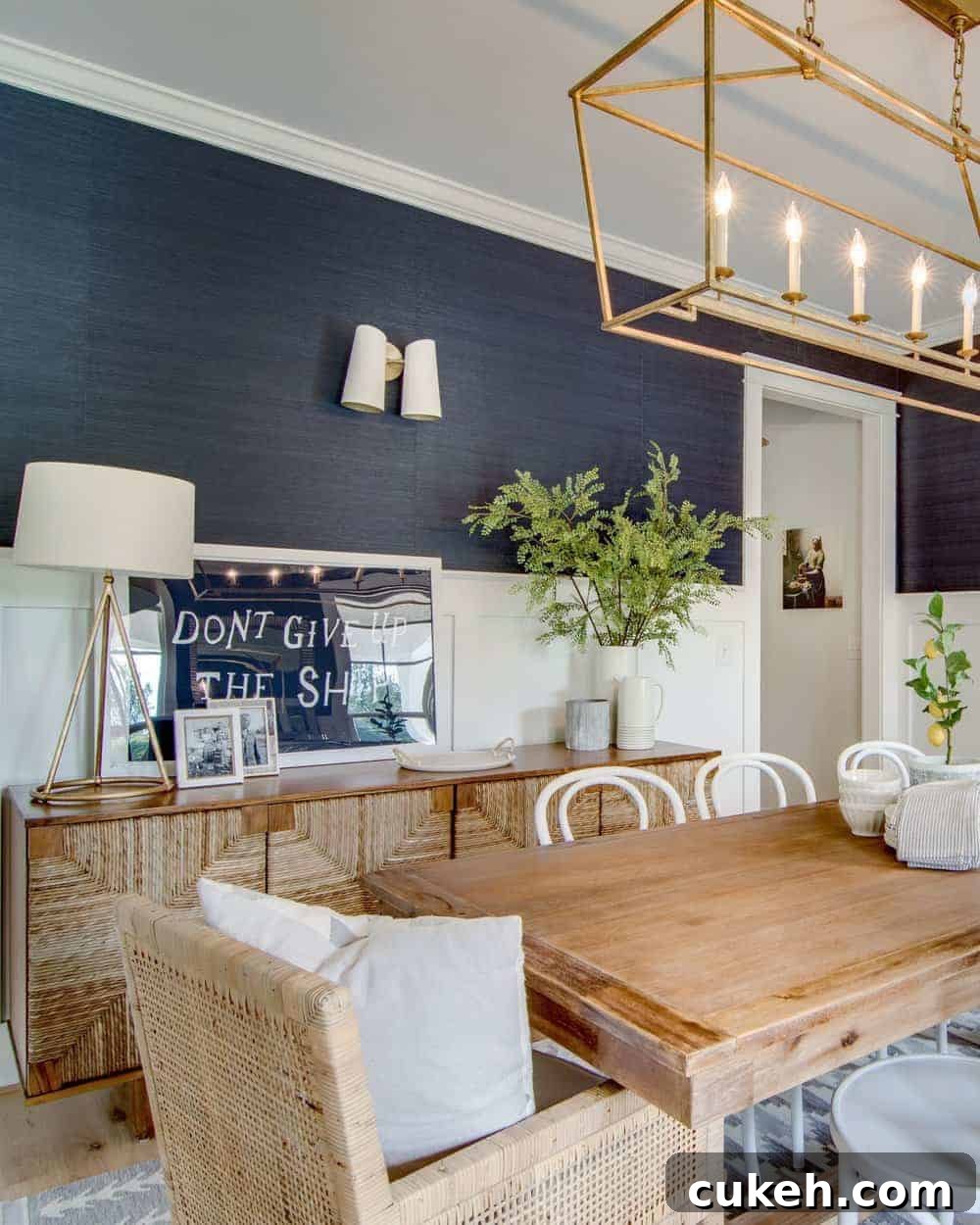 brass visual comfort darlana lighting in a navy blue dining room