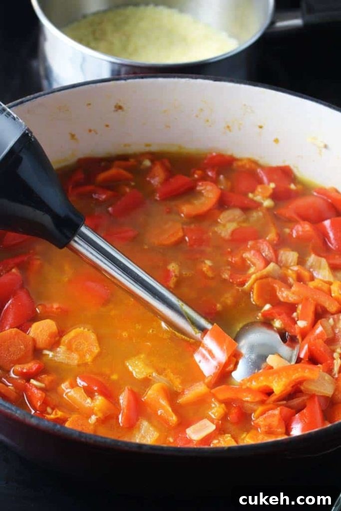 This red pepper carrot soup gets a ton of flavor from harissa, and is extra satisfying on a chilly fall evening with the amazing addition of a couscous swirl.