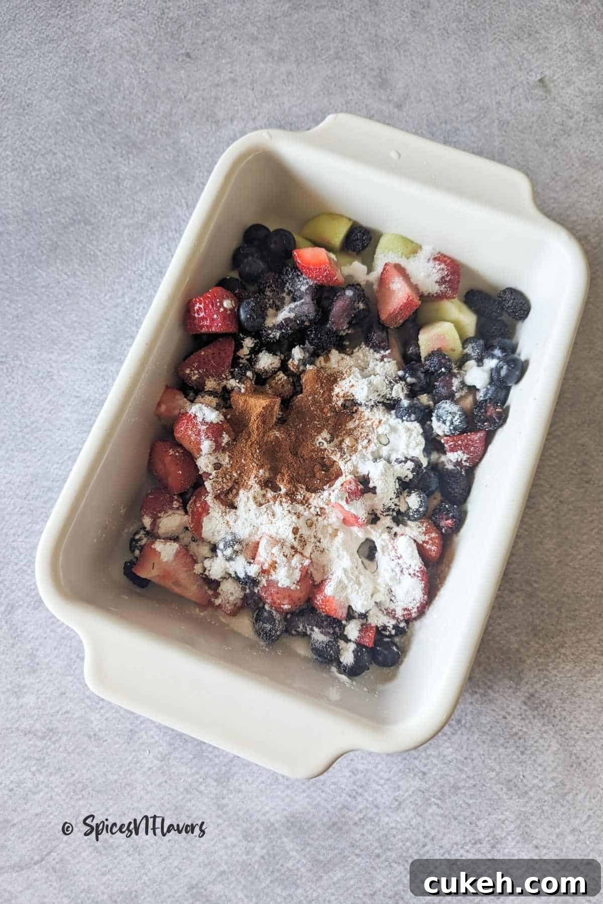 fruits mixed with spices in the baking dish