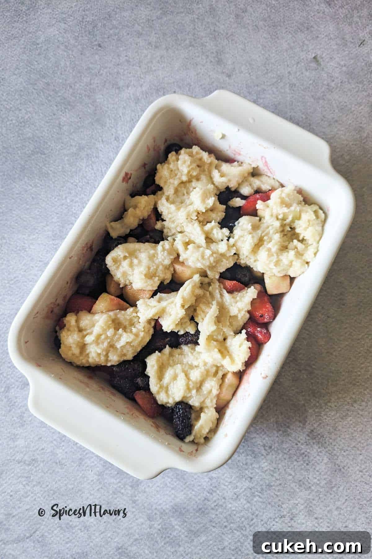 Drop spoonful of batter over fruits
