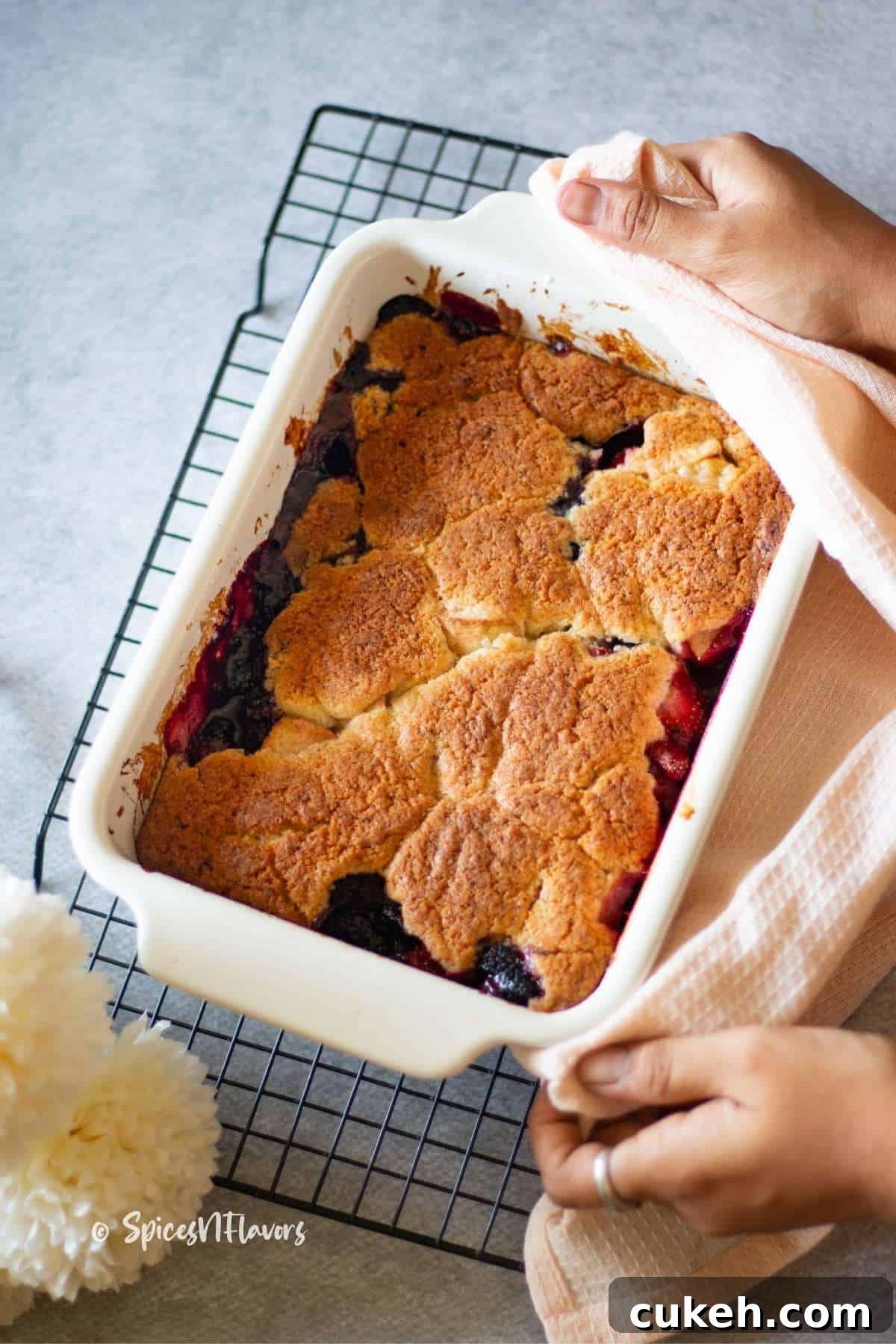baked fruit cobbler placed on a wire rack to cool a bit