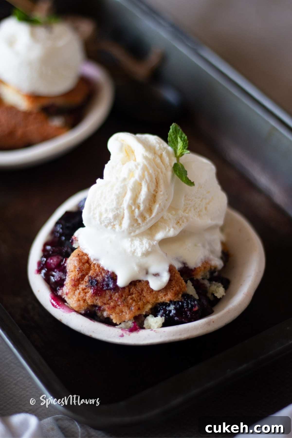 berry cobbler served with ice cream on top