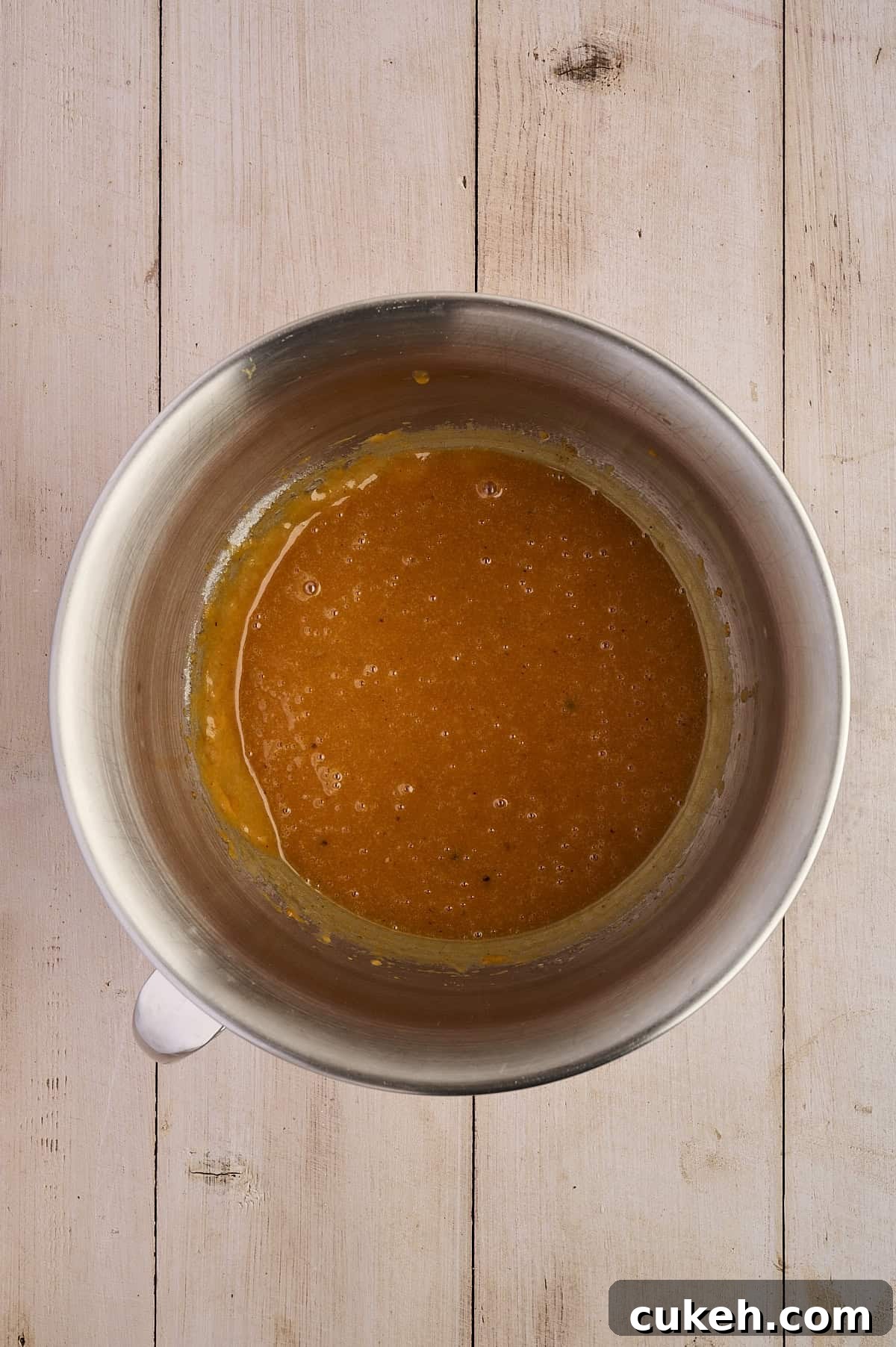 Pumpkin puree, eggs, sugar, vanilla in a mixing bowl.