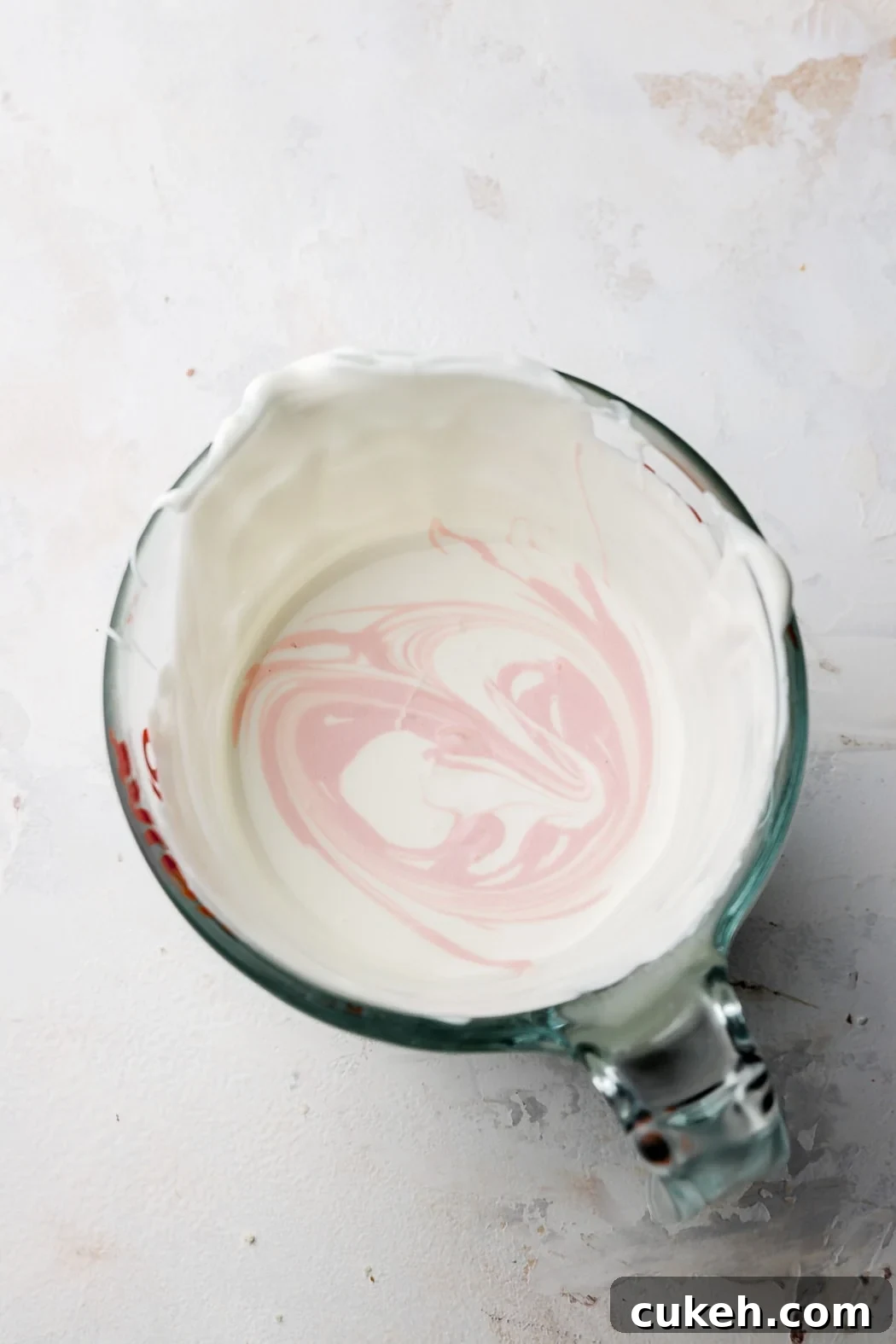 drizzle a little colored white chocolate into the white, then dip, repeat if needed