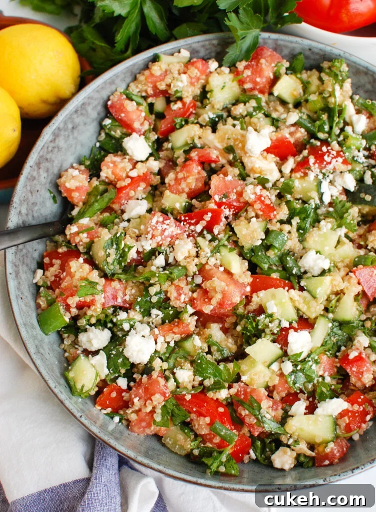 Tomato Cucumber Feta Quinoa Salad with spoon