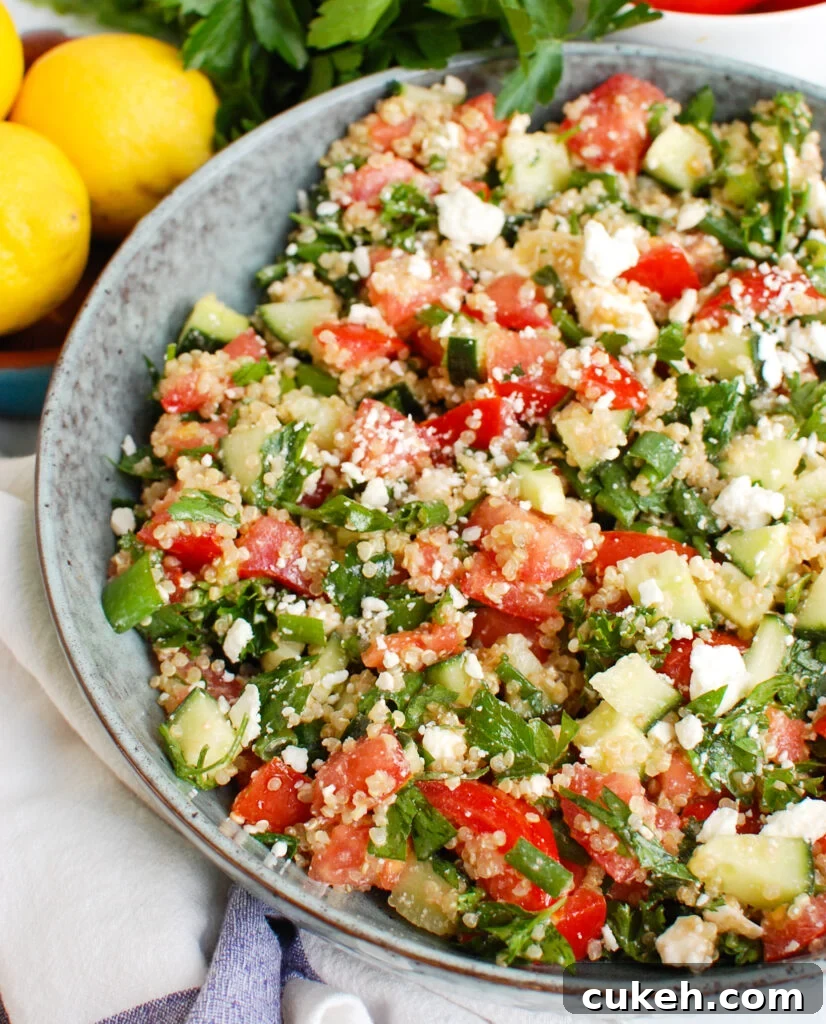 Tomato Cucumber Feta Quinoa Salad in a blue bowl