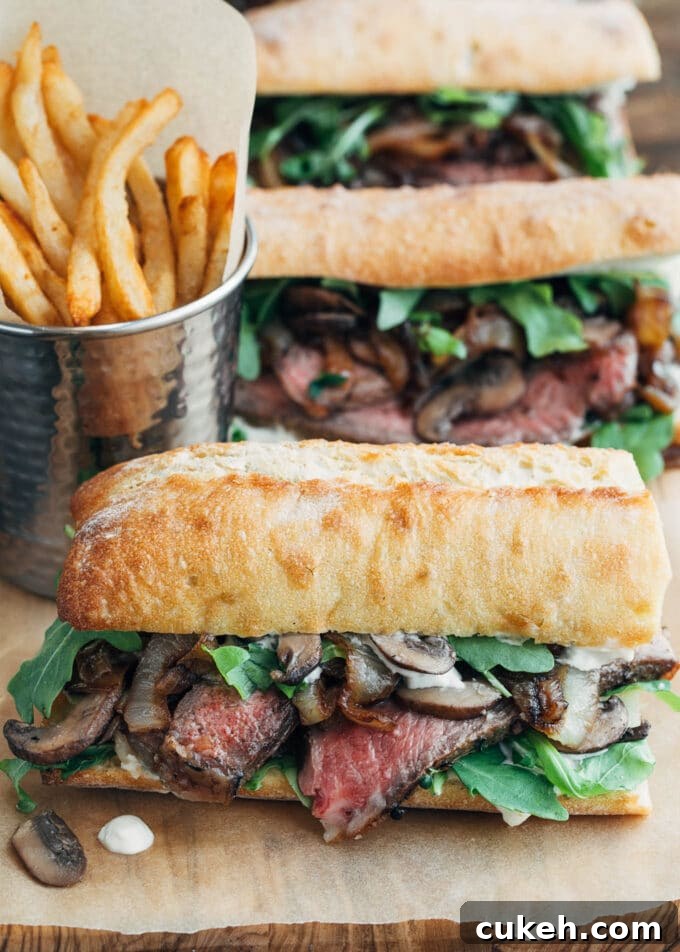 steak sandwiches with horseradish mayo on a wood board