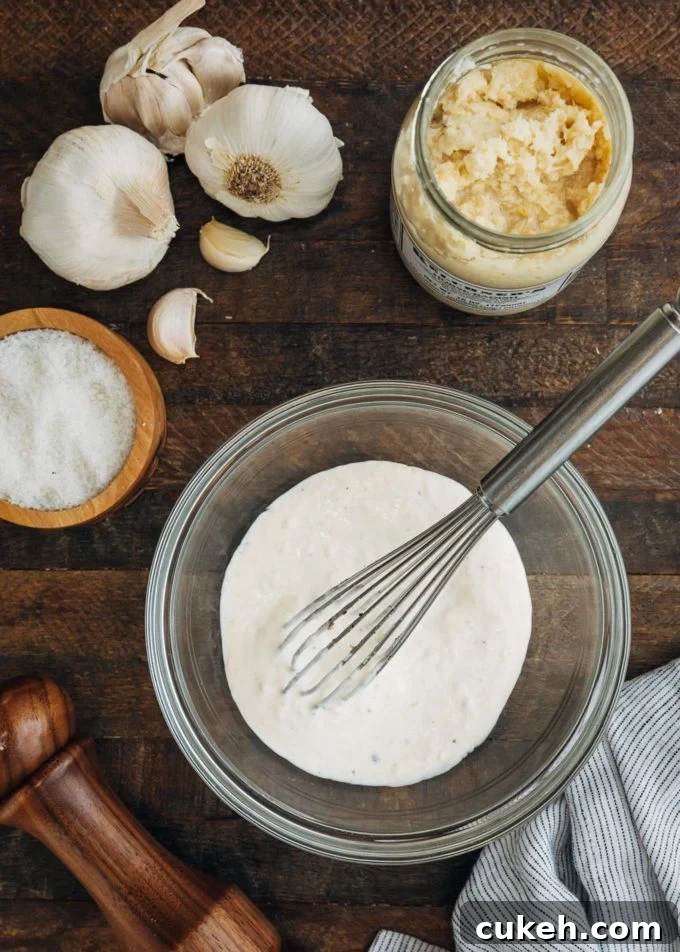 horseradish aioli in a bowl with a whisk