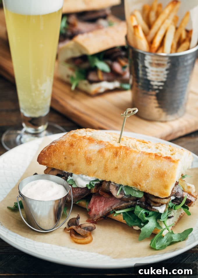 steak sandwich served with horseradish mayo, french fries, and beer