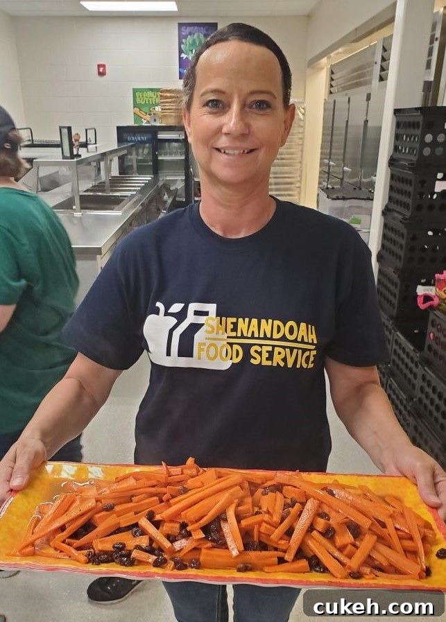 Mastering Vegetable Steaming: Techniques for Better Flavor & Texture 4 food service professional with tray of carrots.