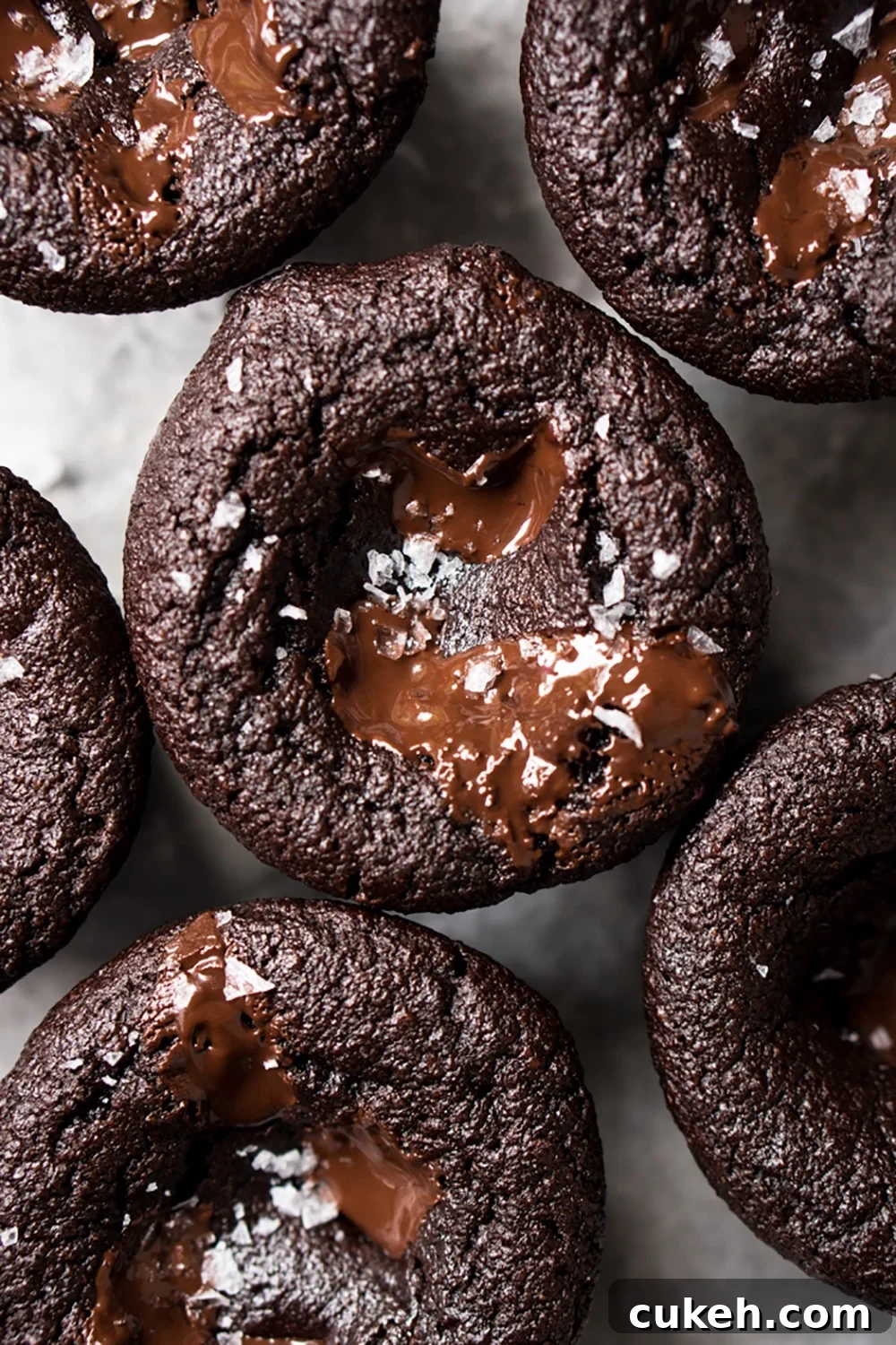 Freshly baked keto chocolate muffins with gooey chocolate and flaky sea salt