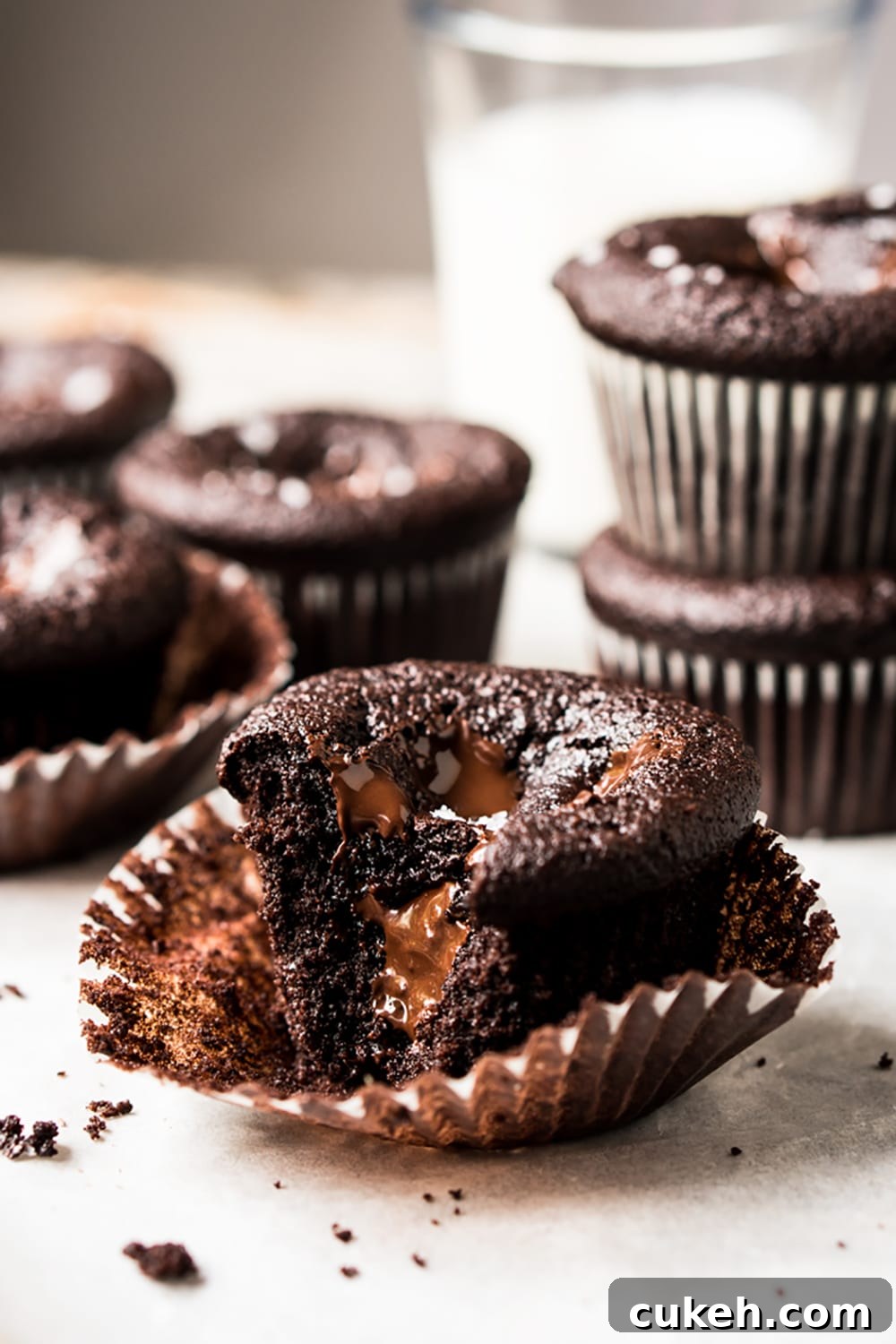 Keto chocolate muffin with a chunk bitten off
