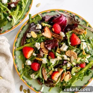 Berry and fig salad on a plate, topped with goat cheese.