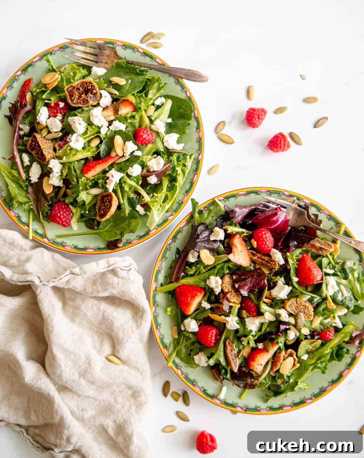 Strawberry goat cheese salad in two plates.