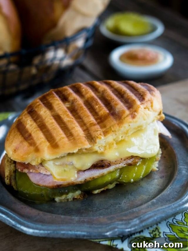 64 Tasty Leftover Ham Recipes for Every Meal 12 Image of a panini pressed cubano sandwich filled with pork, cheese, and ham
