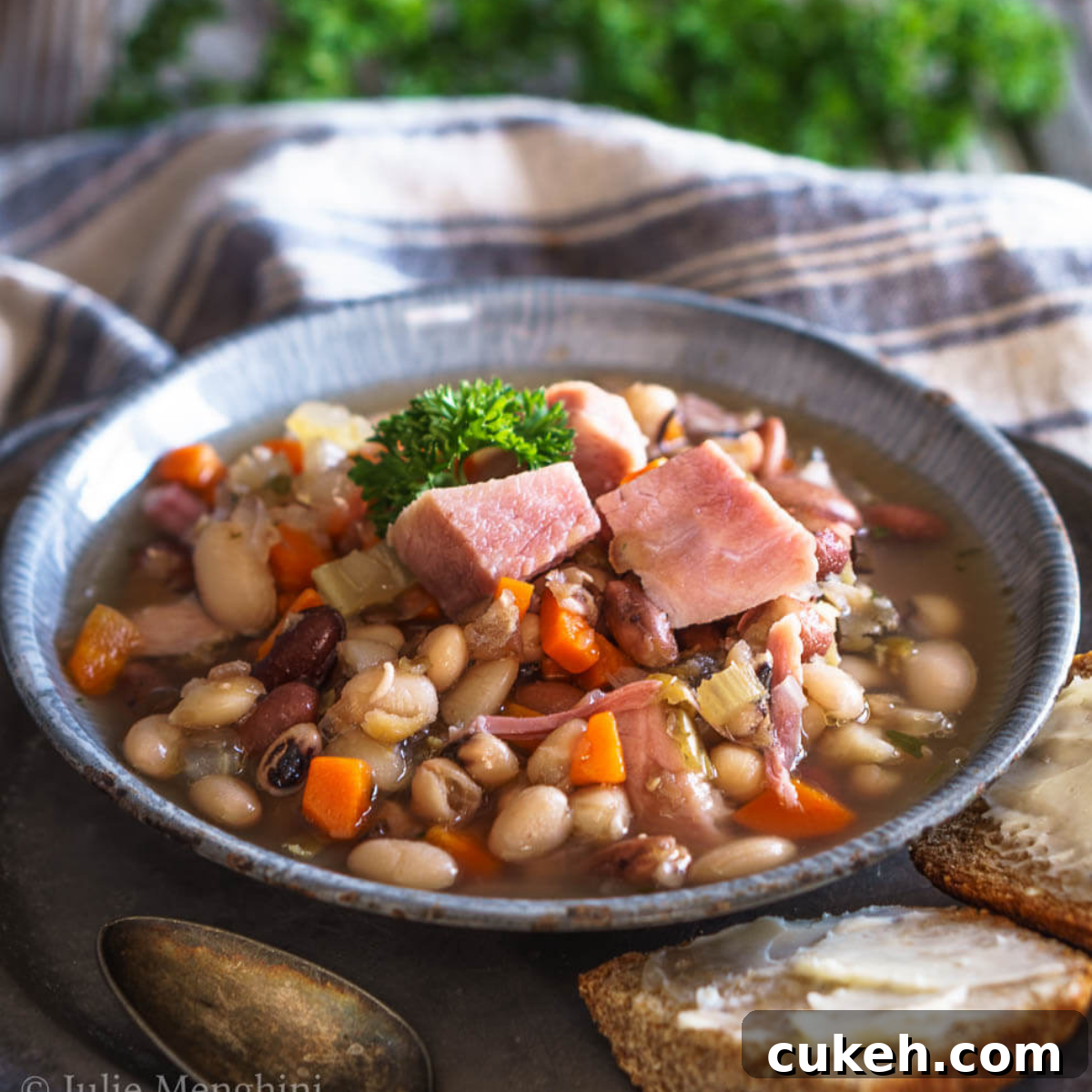 64 Tasty Leftover Ham Recipes for Every Meal 5 A bowl filled with ham, beans, carrots and celery.