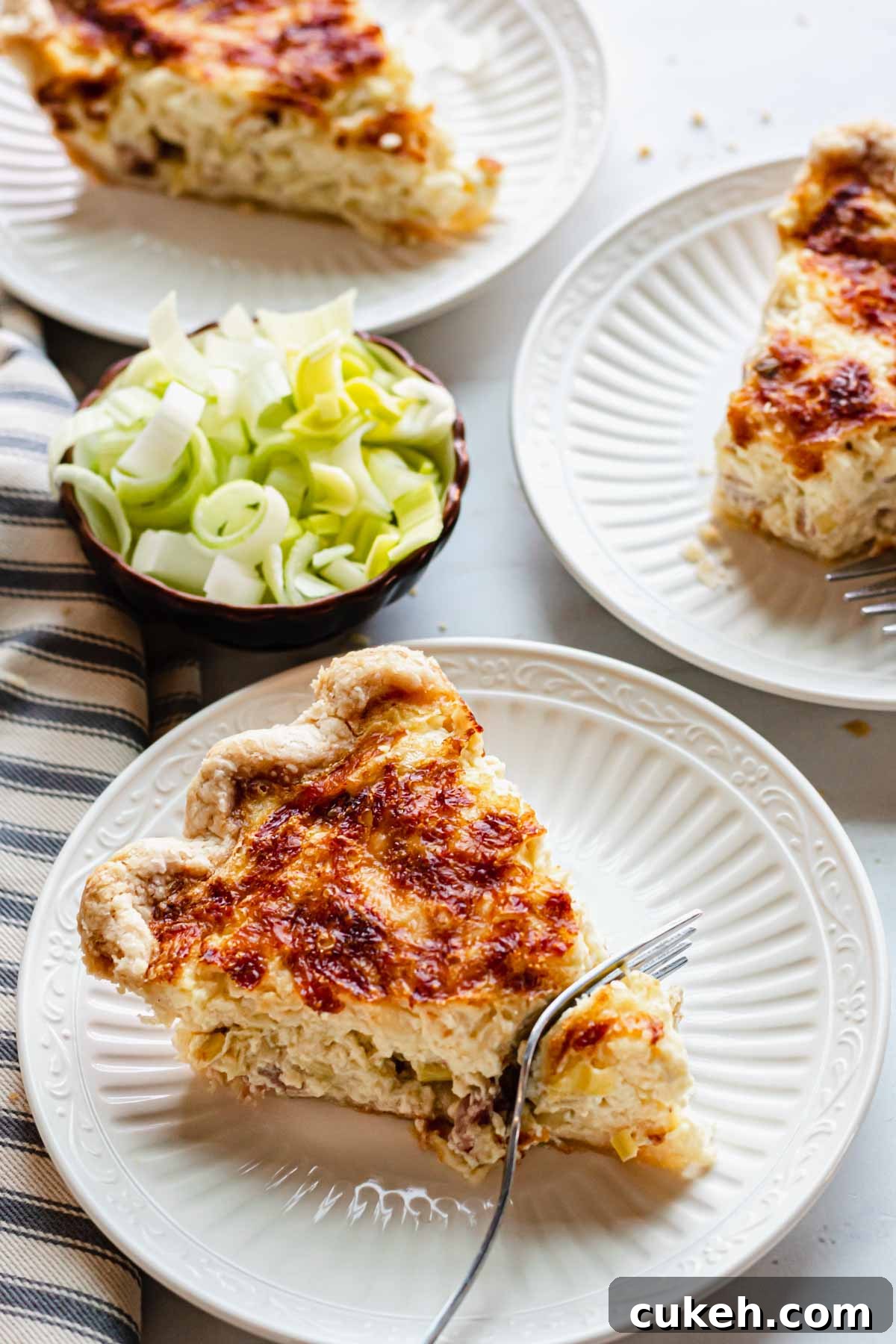 64 Tasty Leftover Ham Recipes for Every Meal 10 Sideview of plates holding slices of quiche.