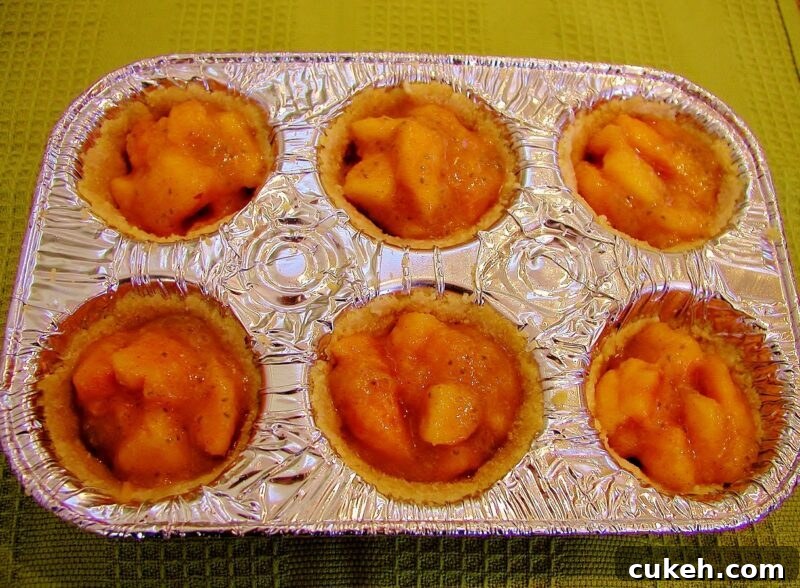 Crust with peach filling before baking