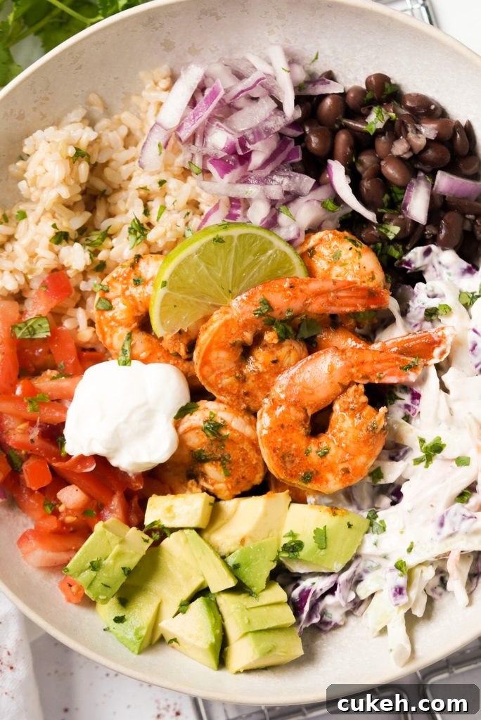 Crispy Baja Shrimp Tacos Bowl with Tangy Cilantro Slaw 11 taco bowl with seasoned shrimp, pico de gallo, brown rice, black beans, crunchy slaw, and avocado