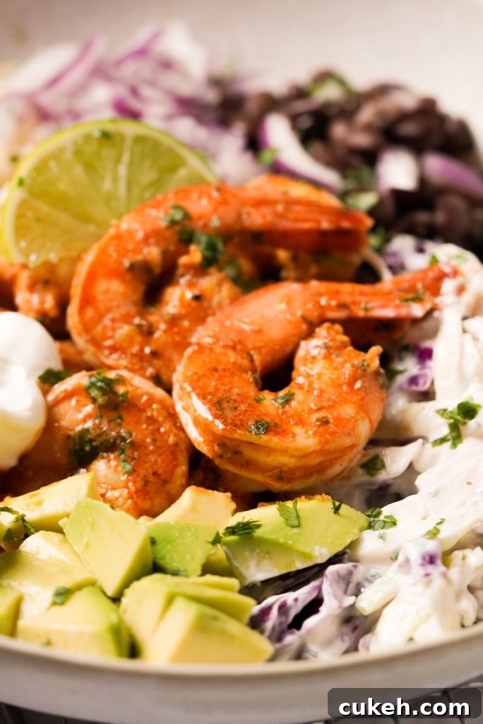 Crispy Baja Shrimp Tacos Bowl with Tangy Cilantro Slaw 3 close up shot of seasoned shrimp with crunchy slaw and avocado