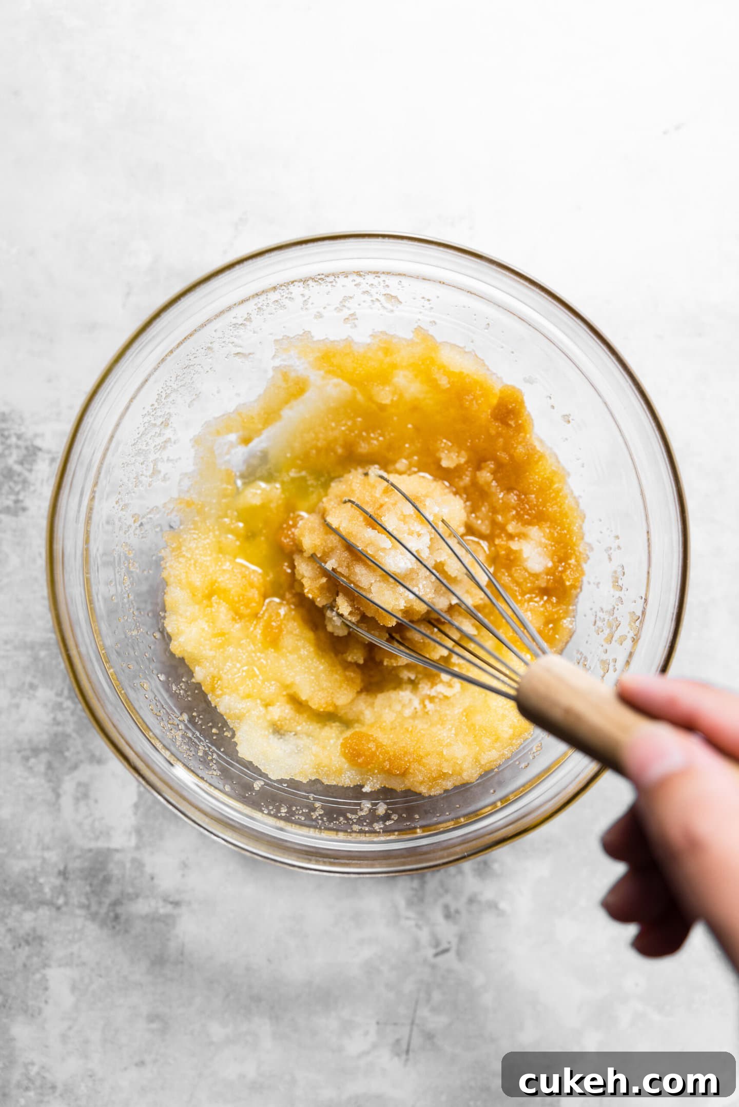 Butter, oil, and sugars being whisked together