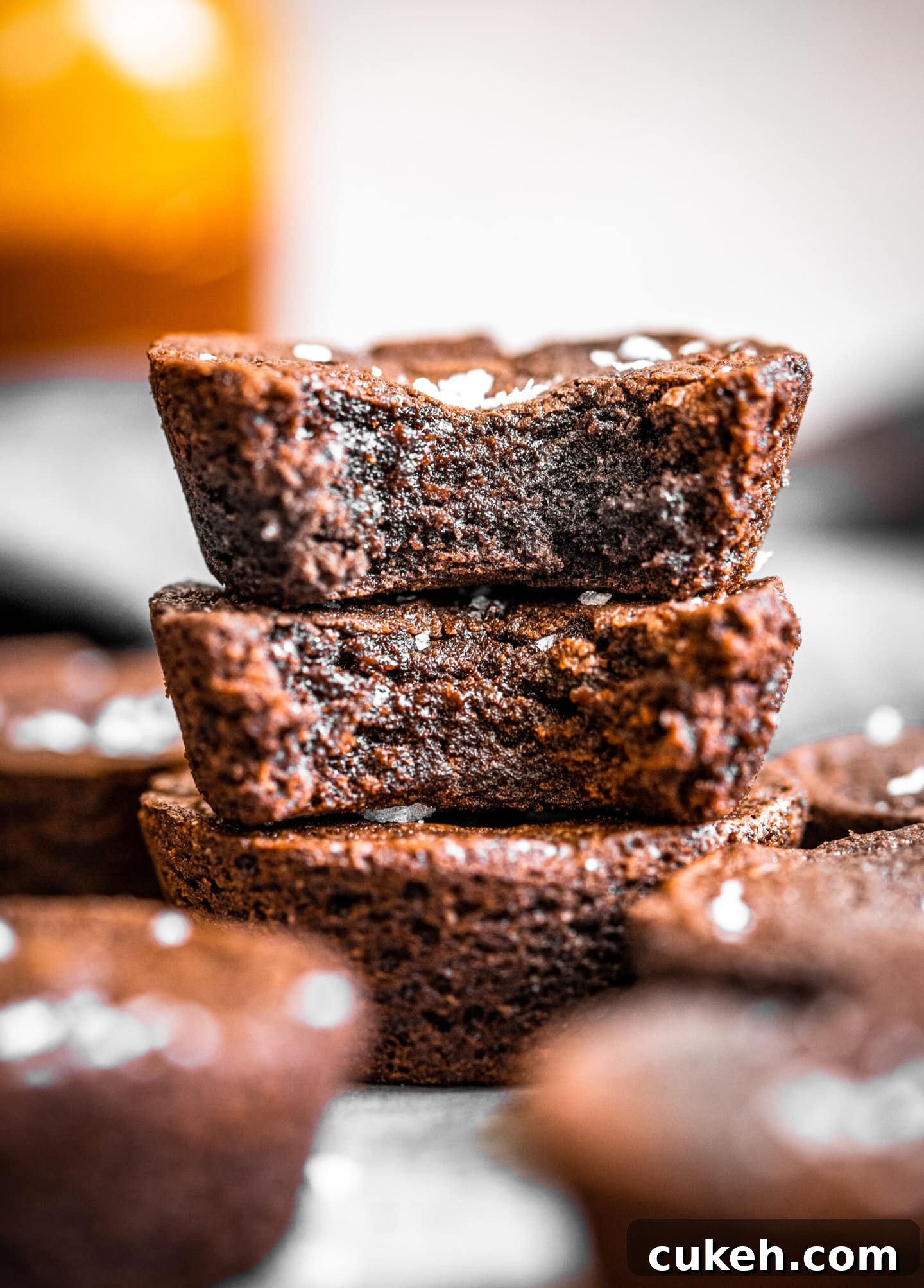 Close up of stack of brownie cups with bites missing showing fudgy interior