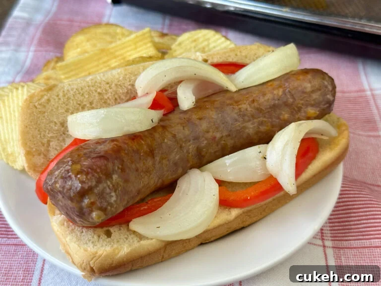 Italian sausage on brat or sausage roll covered with bell peppers and onions