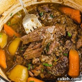 close up shot of a pot of Pot Roast garnished with parsley
