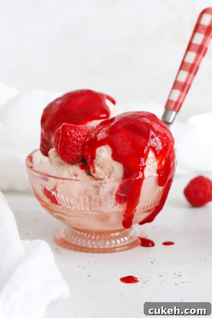 Front view of strawberry ice cream covered with raspberry sauce