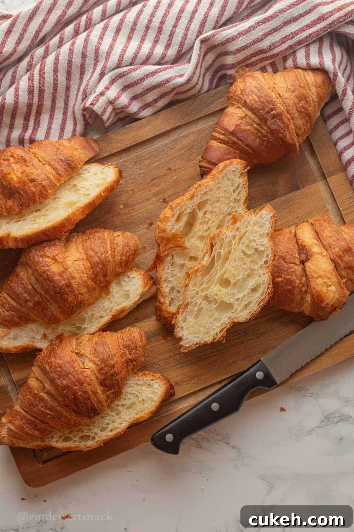 Sliced croissants on cutting board.
