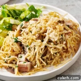 Turkey Tetrazzini and salad on a white plate.