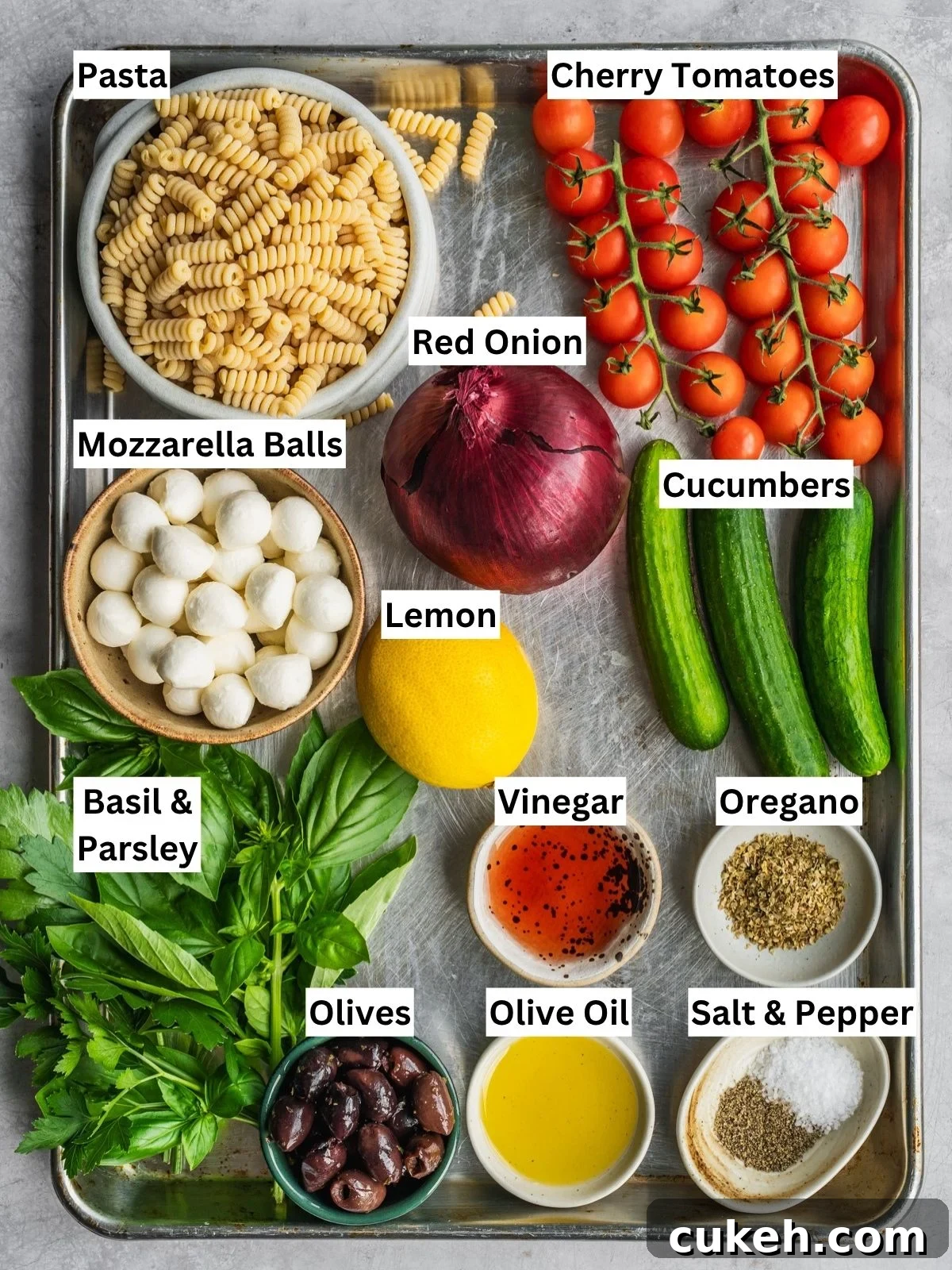 Mediterranean pasta salad recipe ingredients with individual labels in a tray.