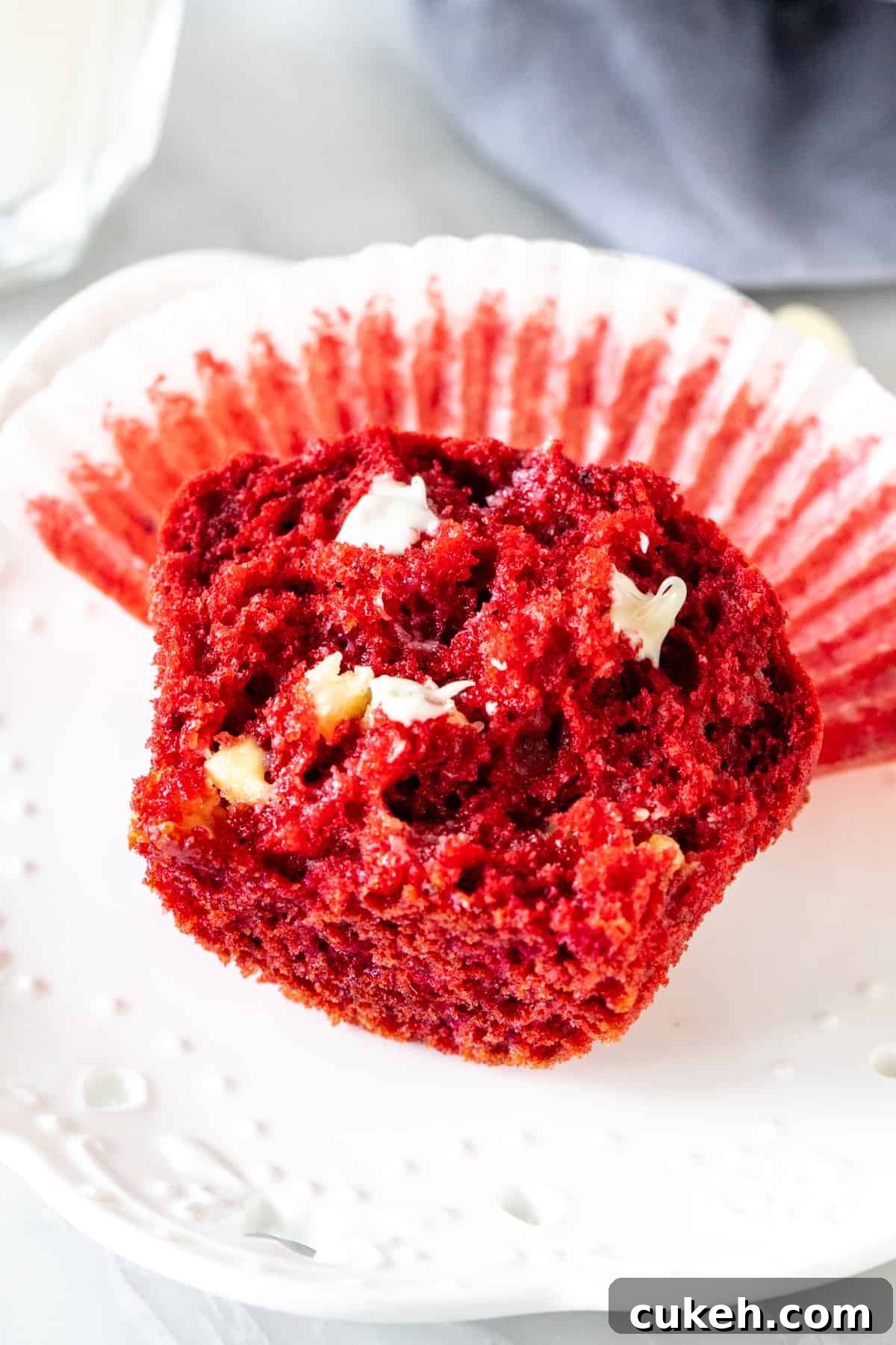 Half of a red velvet muffin on a plate