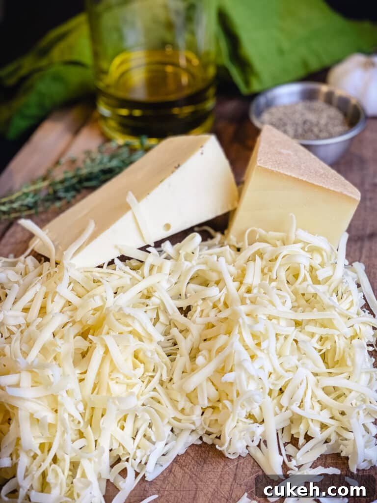 shredded cheeses on a cutting board with olive oil and herbs