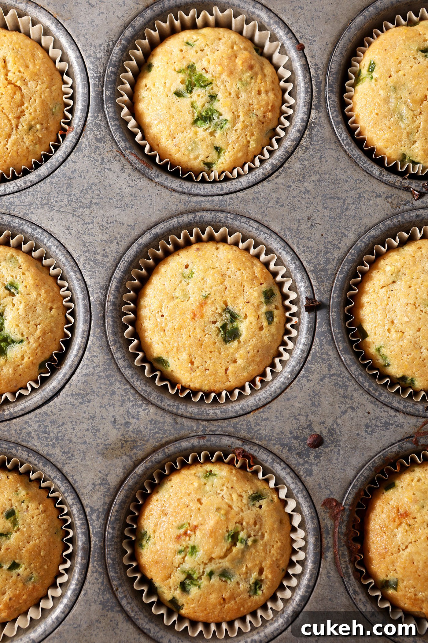 Honey Jalapeño Cornbread Muffins That Balance Sweet and Heat 6 Honey Jalapeno Cornbread Muffins in a tin after baking