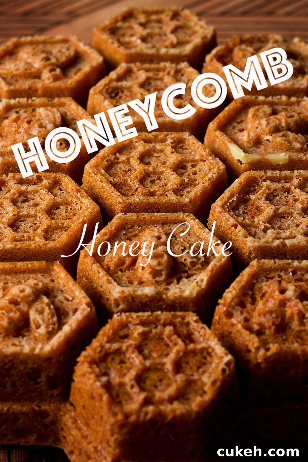 A freshly baked Honey Cake, baked in a Honeycomb Pan, on a wood serving tray.