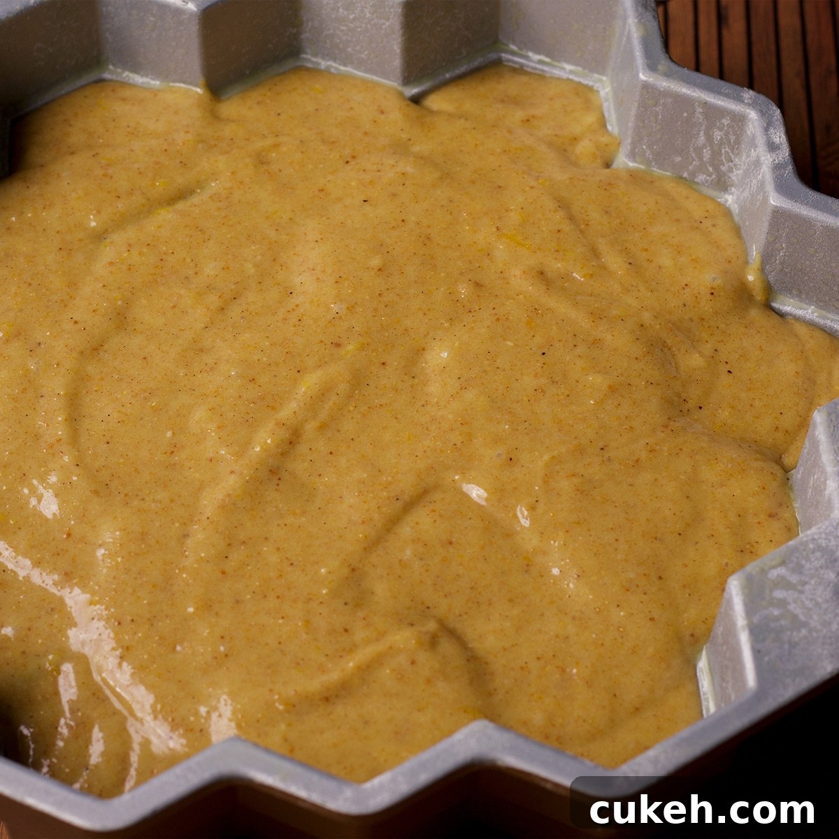 Honey cake batter in a honeycomb pan, ready to bake.