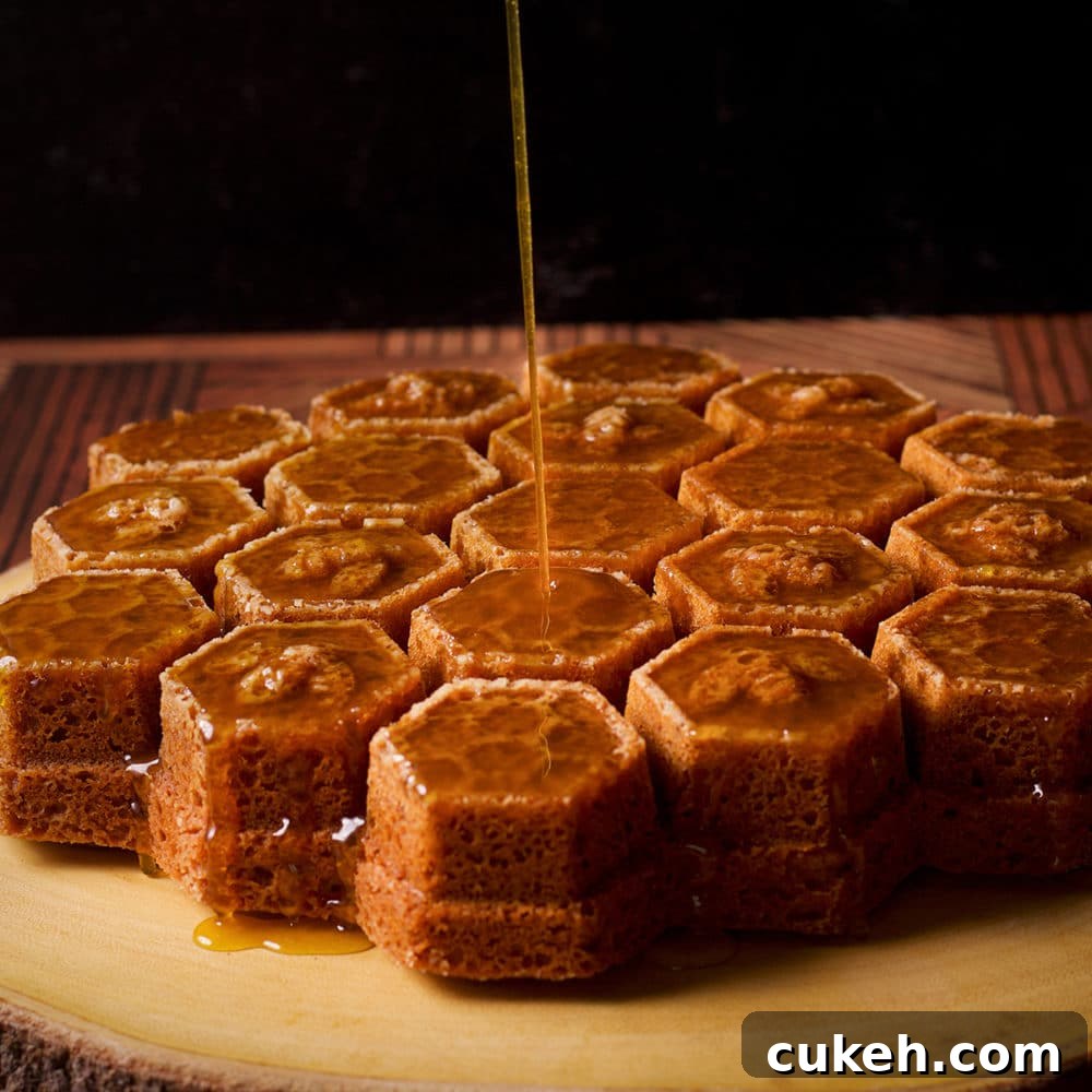 Pouring whisky sauce over the top of a freshly baked honey cake.