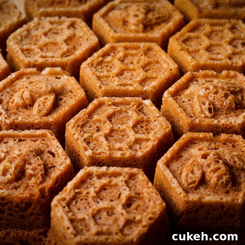 A freshly baked Honey Cake, baked in a Honeycomb Pan, on a wood serving tray.