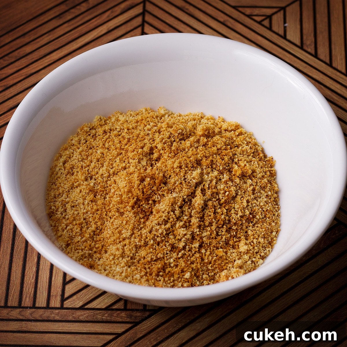A small white bowl containing toasted almond flour.
