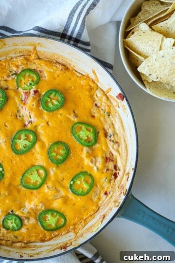 Jalapeno dip in skillet with tortilla chips.