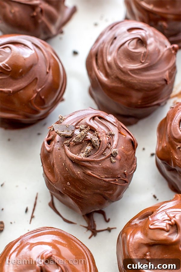 Chocolate Chip Cookie Dough Truffles (V+GF): Decadent cookie dough centers studded with chocolate chips and encased in a smooth, dark chocolate shell. BEAMINGBAKER.COM. #Vegan #GlutenFree