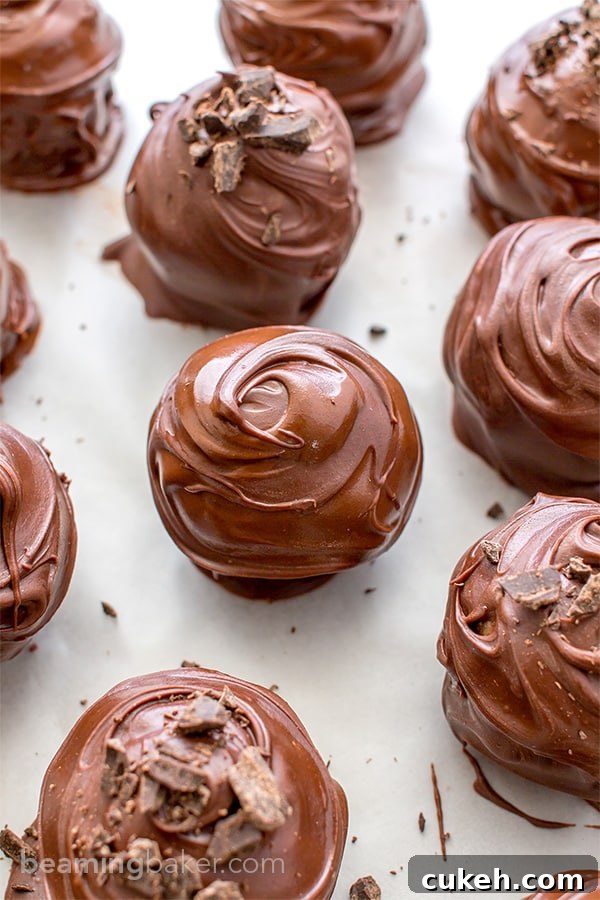 Chocolate Chip Cookie Dough Truffles (V+GF): Decadent cookie dough centers studded with chocolate chips and encased in a smooth, dark chocolate shell. BEAMINGBAKER.COM. #Vegan #GlutenFree